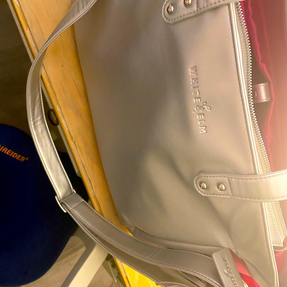 White Elm Aquila office bag new silver outside hit pink satin inside.